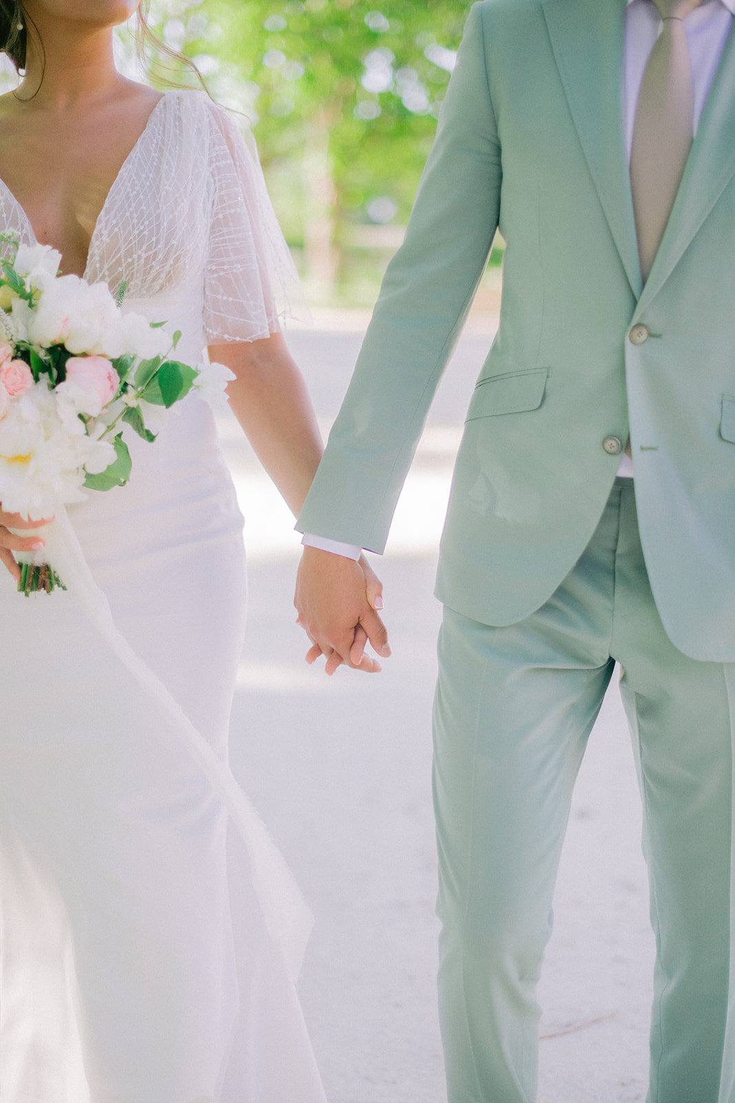  bride and groom hold hands